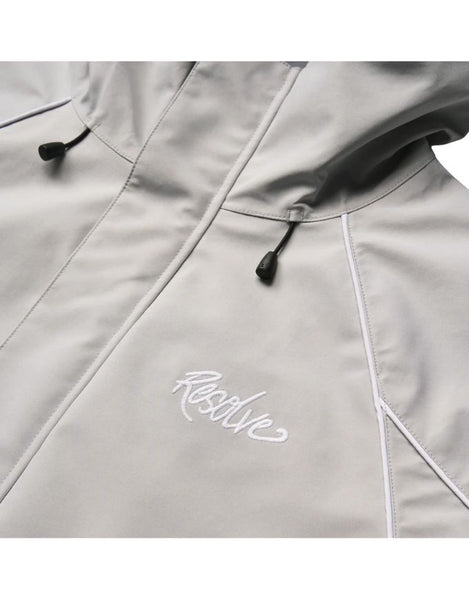 Close-up of a light gray jacket with a brand logo on a white background