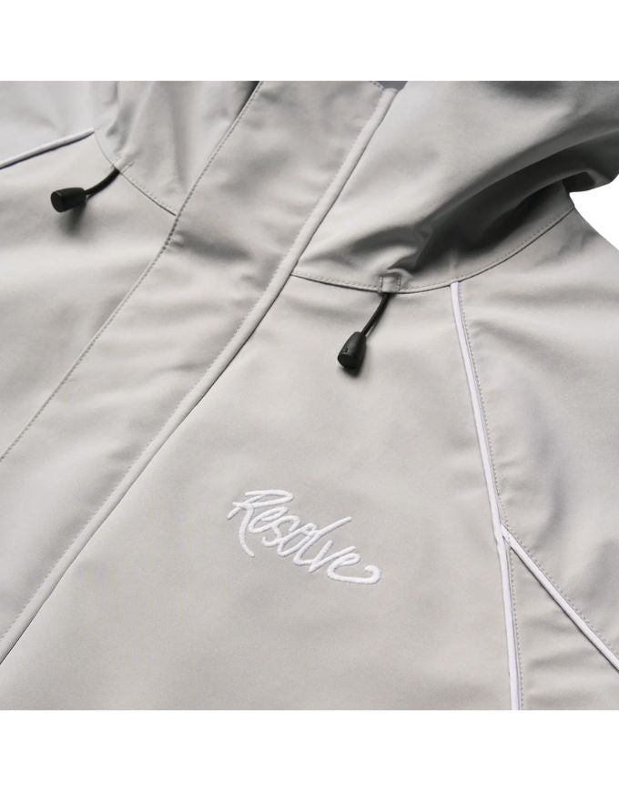 Close-up of a light gray jacket with a brand logo on a white background