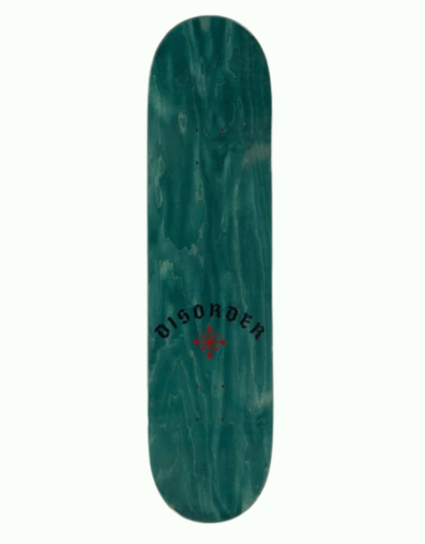 A teal green skateboard deck with a natural wood grain pattern, featuring the word 'DISORDER' in black arched text and a red cross logo in the center, shown against a plain white background.