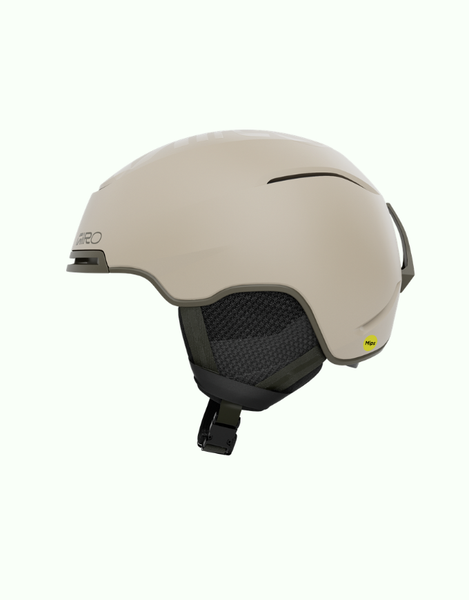 A matte beige ski helmet with a black chin strap and interior padding, shown from a side profile on a light off-white background.