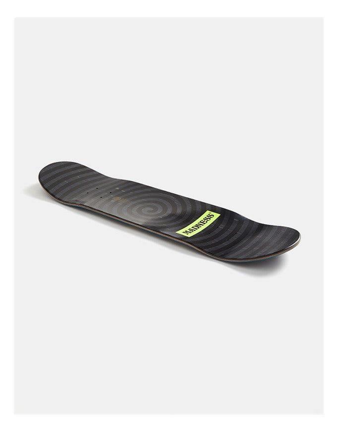 A black skateboard deck with a subtle circular graphic pattern and a lime green 'YANKEES' brand sticker, shown on a light gray background.