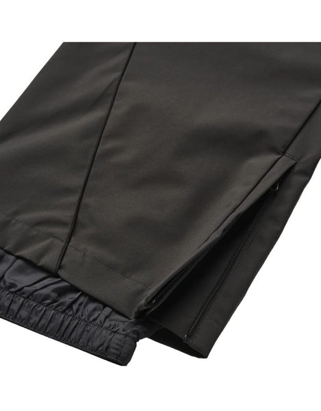 Close-up of black pants with a white background
