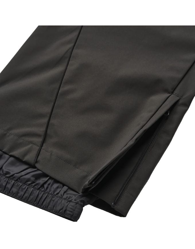 Close-up of black pants with a white background