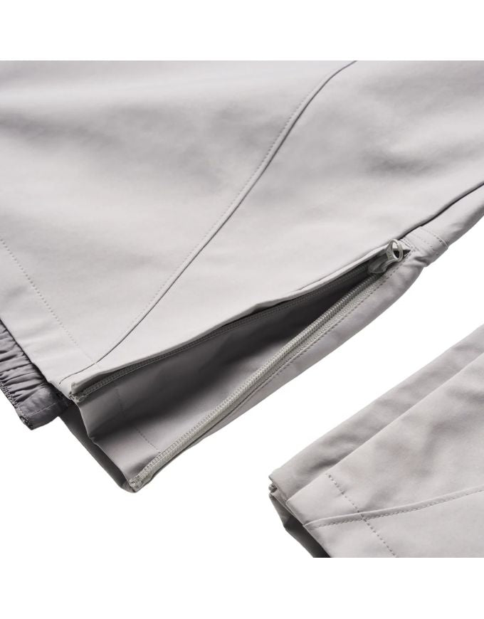 Close-up of gray pants with a zipper on a white background