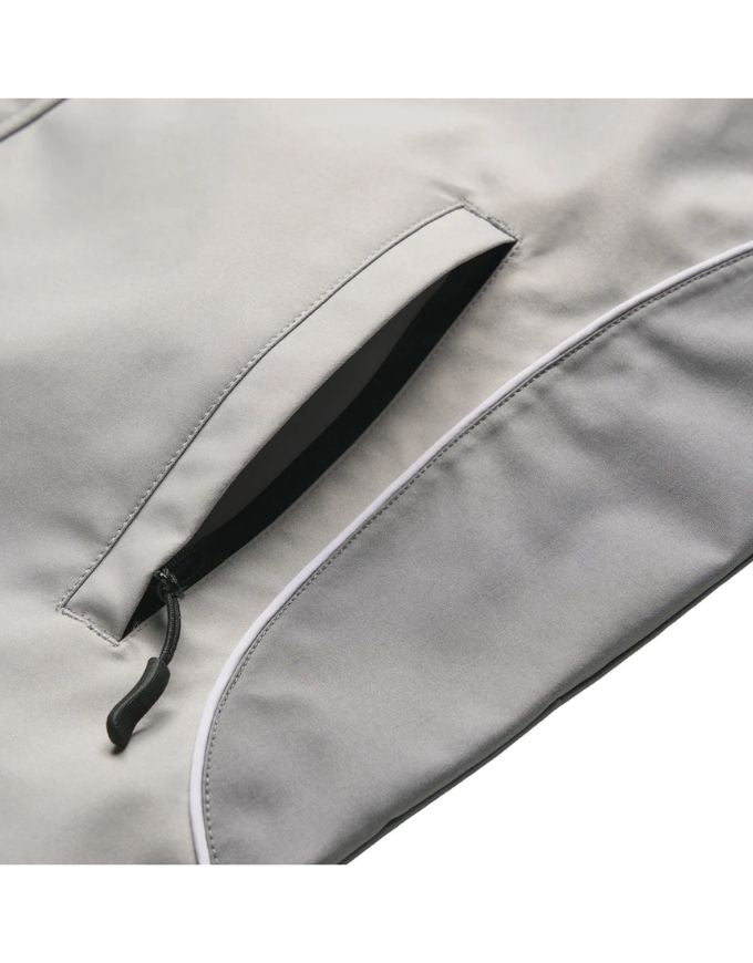 Close-up of a gray jacket with a zipper pocket on a white background