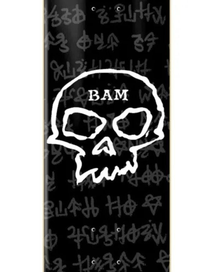 A close-up of a black skateboard deck featuring a large white skull graphic with the text 'BAM' on the top, surrounded by small white occult-style symbols.