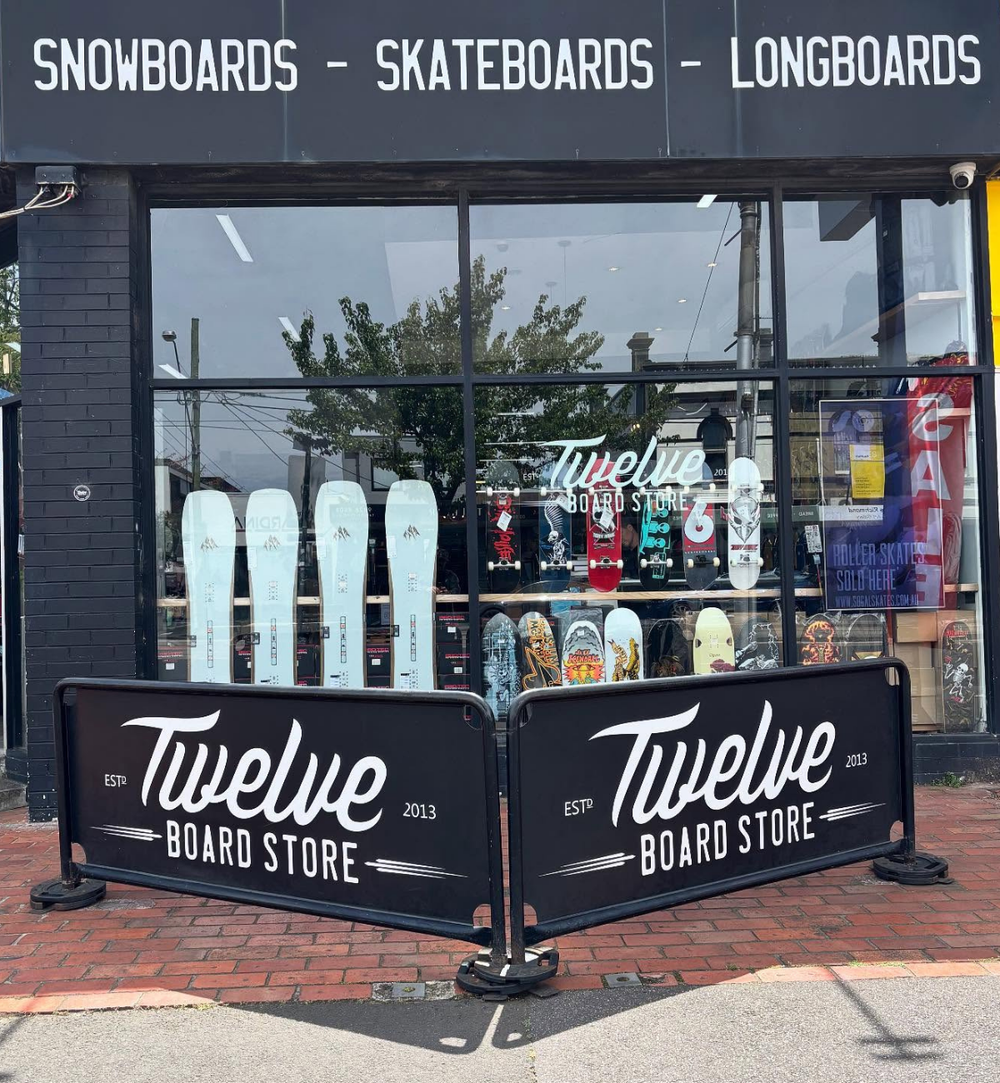 Front of Twelve Board Store with snowboards and skateboards displayed outside